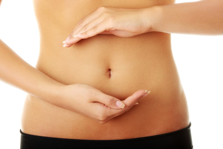 Fit young woman belly with hand on it